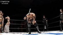 a man in a wrestling ring with the word stardom in the corner