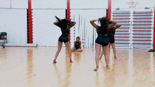 a dance studio with a red exit sign