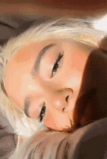 a close up of a woman 's face with the sun shining on her face