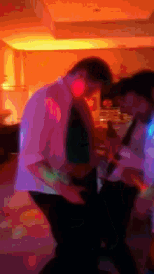 a blurry picture of a man and woman kissing in a dark room