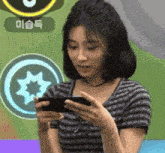 a woman is playing a video game on her phone