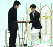 two men standing next to each other in front of a screen that says ' i love you '