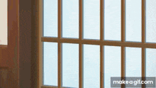a close up of a window with a wooden frame and a sliding glass door .