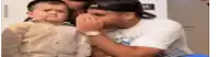 a man is kissing a baby on the cheek .