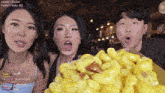 a man and two women are eating macaroni and cheese in front of a screen that says today 's subs : 62