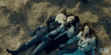 two women laying in the grass with the letters hw on the bottom left