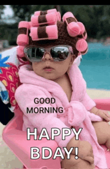 a baby with curlers on her head and sunglasses is wearing a pink robe and a bathrobe .