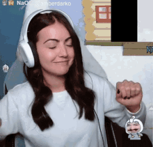 a woman wearing headphones is sitting in front of a screen that says amberdarko