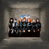 a group of women standing in a room with a window