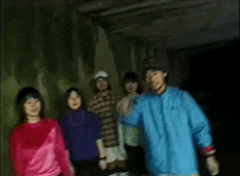 a group of people are posing for a picture in a tunnel