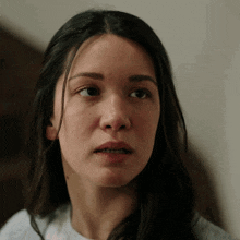 a close up of a woman 's face with her mouth open