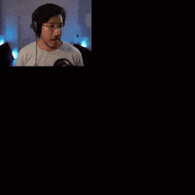 a man wearing headphones says i win in front of a list of five nights at freddy 's cast