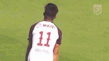 two soccer players are hugging each other and one has the number 11 on his jersey