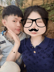 a man and a woman are posing for a picture and the woman is wearing a fake mustache and glasses