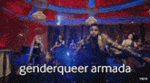 a group of people are dancing in a room with the words `` genderqueer armada '' written above them .