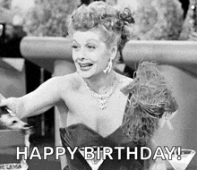 a black and white photo of a woman in a dress sitting at a table with the words `` happy birthday ! ''