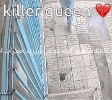 a person walking down a sidewalk with the words " killer queen " written above them