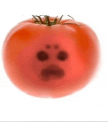 a close up of a tomato with a face drawn on it