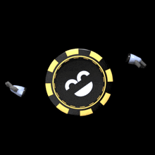 a black and gold poker chip with a smiling face on it