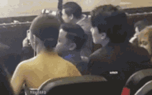 a group of people are sitting in a stadium watching a concert .