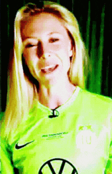 a woman wearing a neon green nike shirt with the number 10 on it