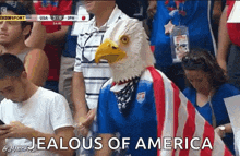a man wearing an eagle mask and an american flag stands in a crowd with the words jealous of america above him