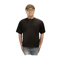 a man wearing glasses and a black t-shirt is standing with his hands in his pockets