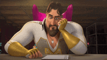 a man in a superhero costume sits at a table with a notepad