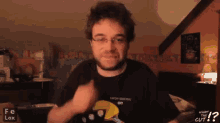 a man wearing glasses and a black shirt that says high security