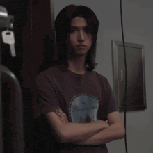 a man wearing a phenomenon t-shirt with his arms crossed