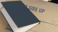 a cardboard box that says side up on it