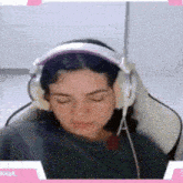 a woman wearing headphones is laying down with her eyes closed