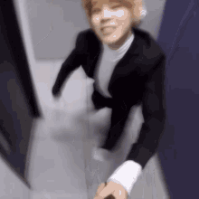 a blurry picture of a man in a suit holding a person 's hand