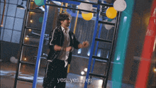 a man is standing on a ladder with balloons and says yes