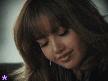 a close up of a woman 's face with a star in the corner