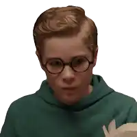 a young boy wearing glasses and a green sweatshirt