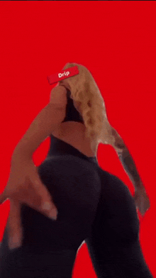 a woman is dancing with a red background and a drip sign on her head