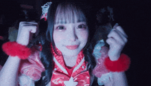 a girl with a tiara on her head is wearing a red and pink dress