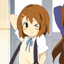 a girl with brown hair is making a funny face while standing next to another girl
