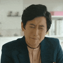 a man with his eyes closed making a funny face