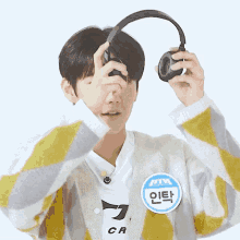 a person with a name tag that says ' cr ' on it is wearing headphones
