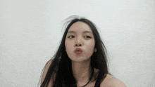 a woman with long hair making a funny face with her mouth open