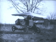 a black and white photo of a vehicle with a white umbrella on top of it