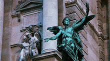 a statue of a man with wings is in front of a building that says eros