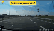 a car is driving down a highway with a sign above it that says bardzo mocno placzesz ulco