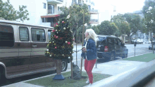 Hit Human Christmas Tree GIF - Hit Human Christmas Tree Mime Strike GIFs