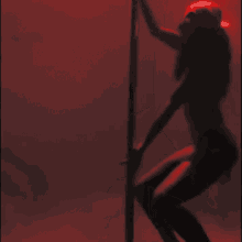 a silhouette of a woman sitting on a chair with a red background