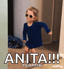 a little girl wearing sunglasses and a blue dress says anita yeahhh