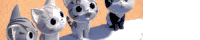 a group of cats standing next to each other on a white surface