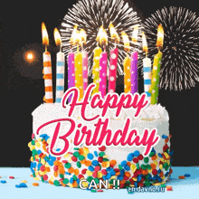 a happy birthday cake with candles and fireworks in the background .